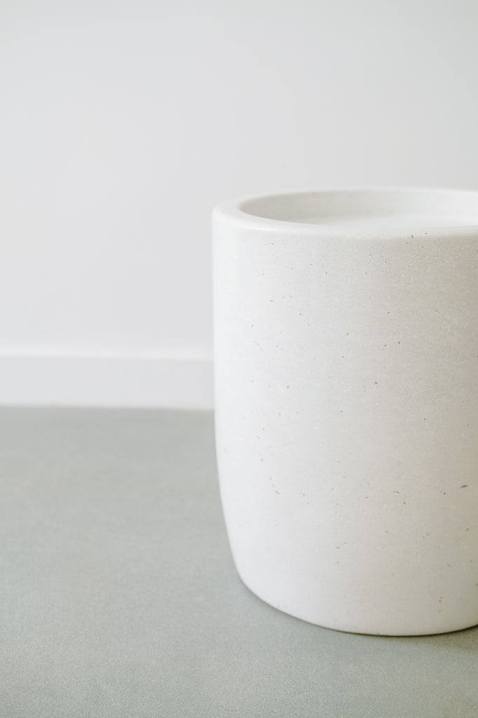 Close up view of an Abalone Terrazzo Side Table against a white wall. - Saffron and Poe