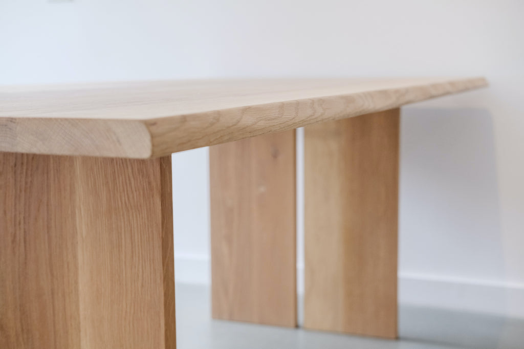 Close up of Live Edge White Oak Dining Table against a white wall. - Saffron and Poe