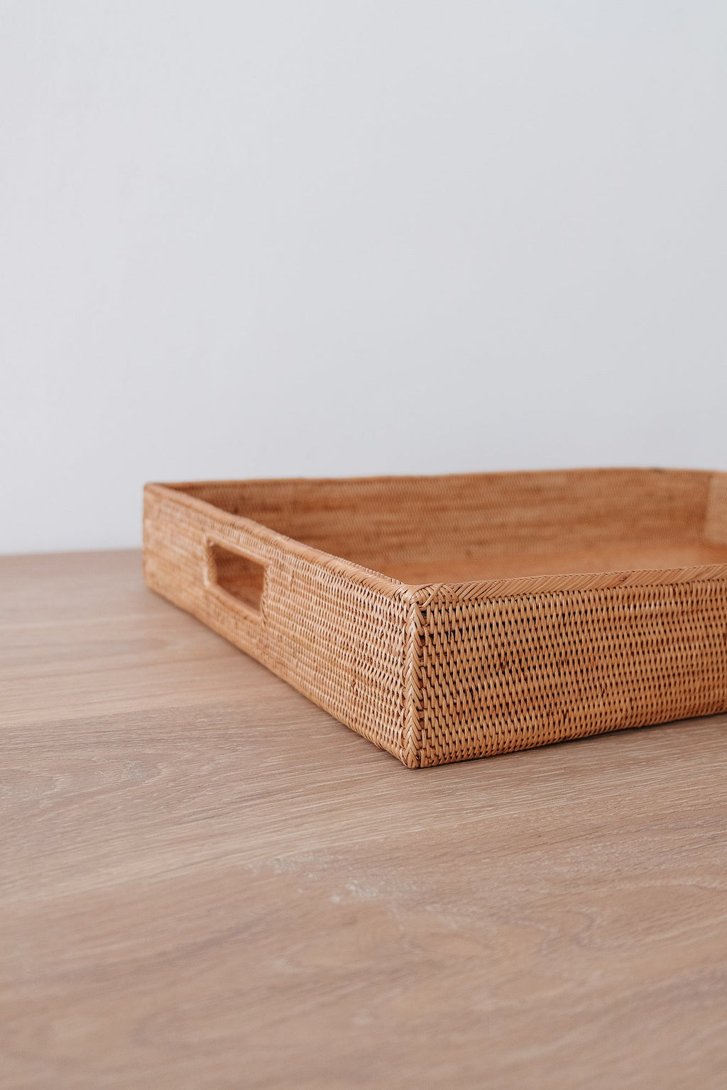 Handwoven Tenganan Basket Tray made from natural Ata reed with intricate weave, placed on wooden surface