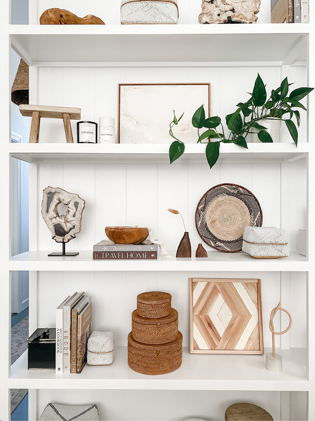 Saffron + Poe Curated Shelf Bundle with decorative bowls, baskets, beads, books, and plants on white shelving unit