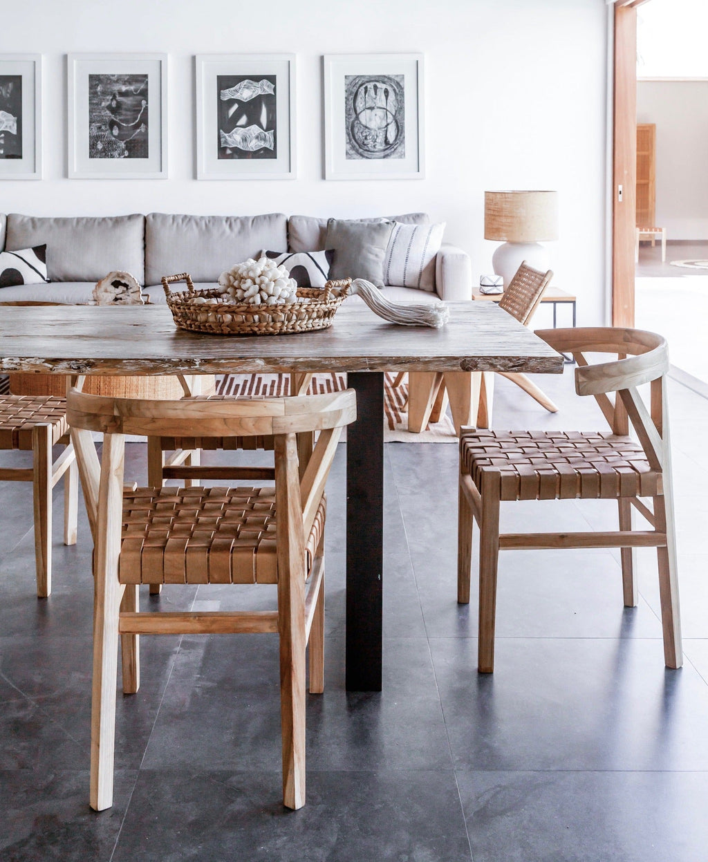 Woven Leather Wishbone dining chairs with teak frame and beige leather straps in modern dining room setting