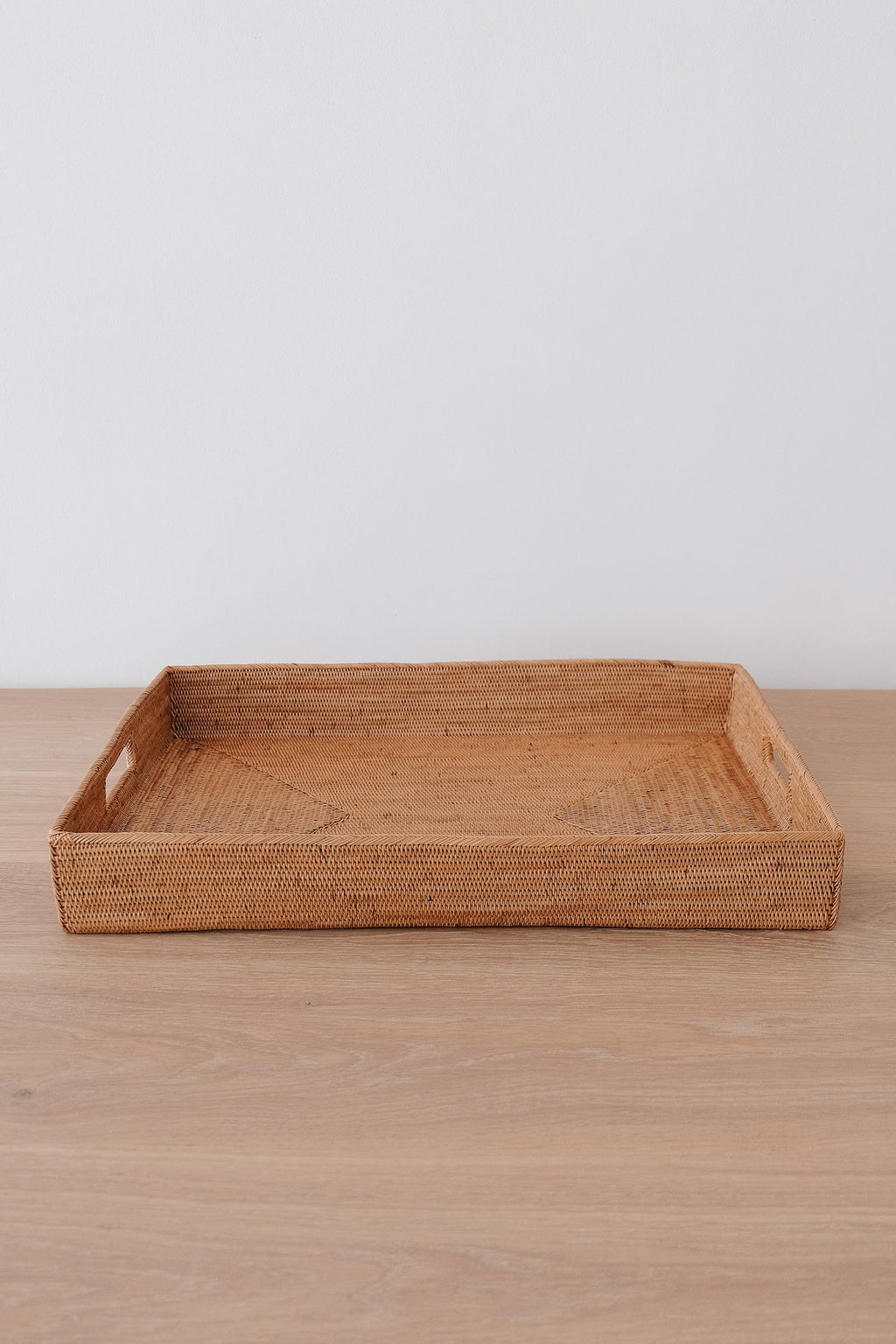 Tenganan Basket Tray handwoven from natural Ata reed with intricate simple weave on wooden surface