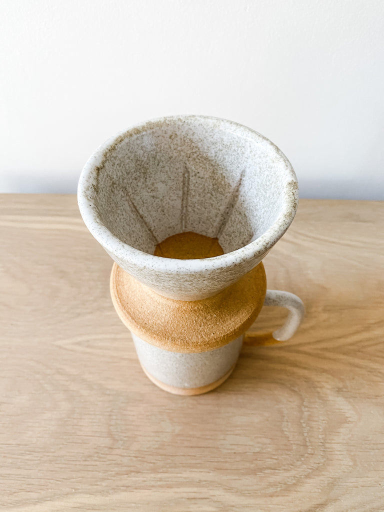 Front angled view of the Uzumati Ceramic Bodie Pour Over on white oak and against a white wall - Saffron and Poe