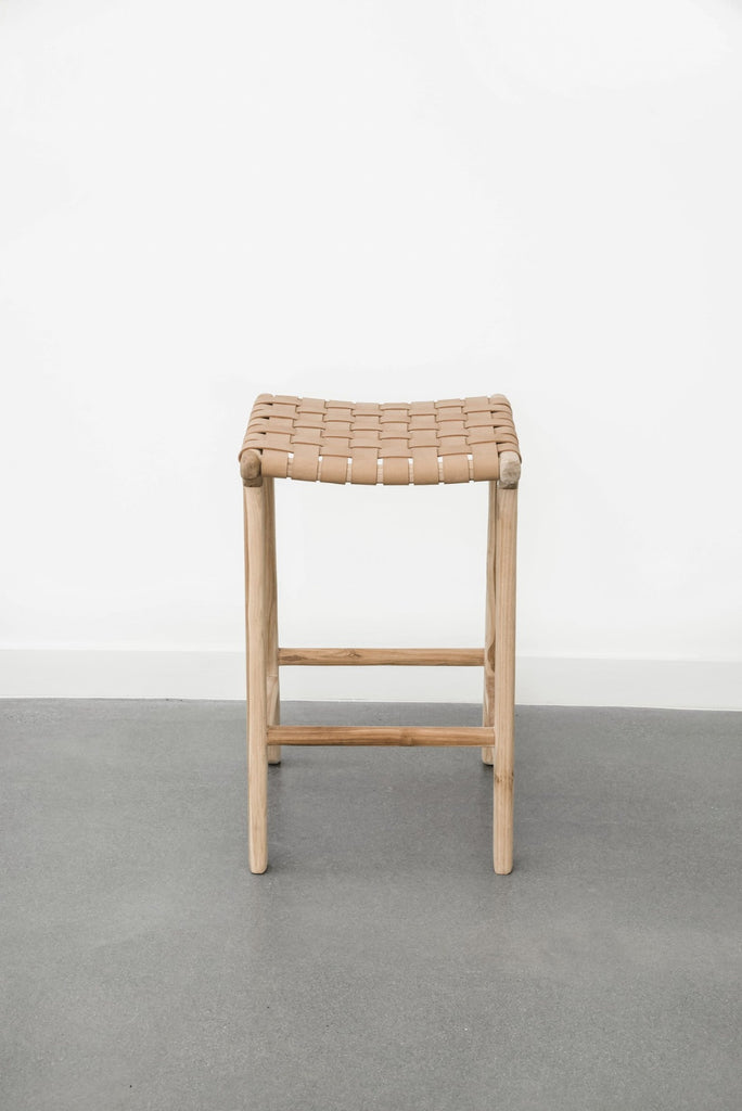 Detailed view of Comfortable, casual, leather-strapped counter height Backless Woven Leather Counter stool in Beige on a white background. Handmade in Bali using Teak wood and vegetable-tanned leather imported from Java. - Saffron and Poe