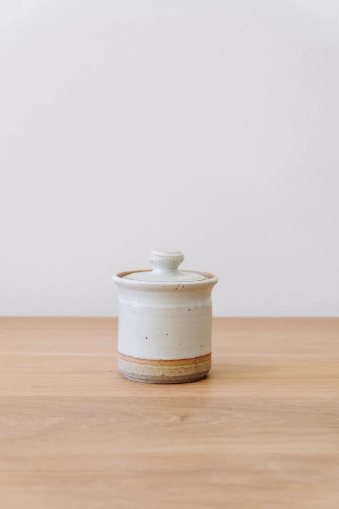 Hand Thrown Ceramic Sugar Jar against white background on an oak table. - Saffron and Poe.