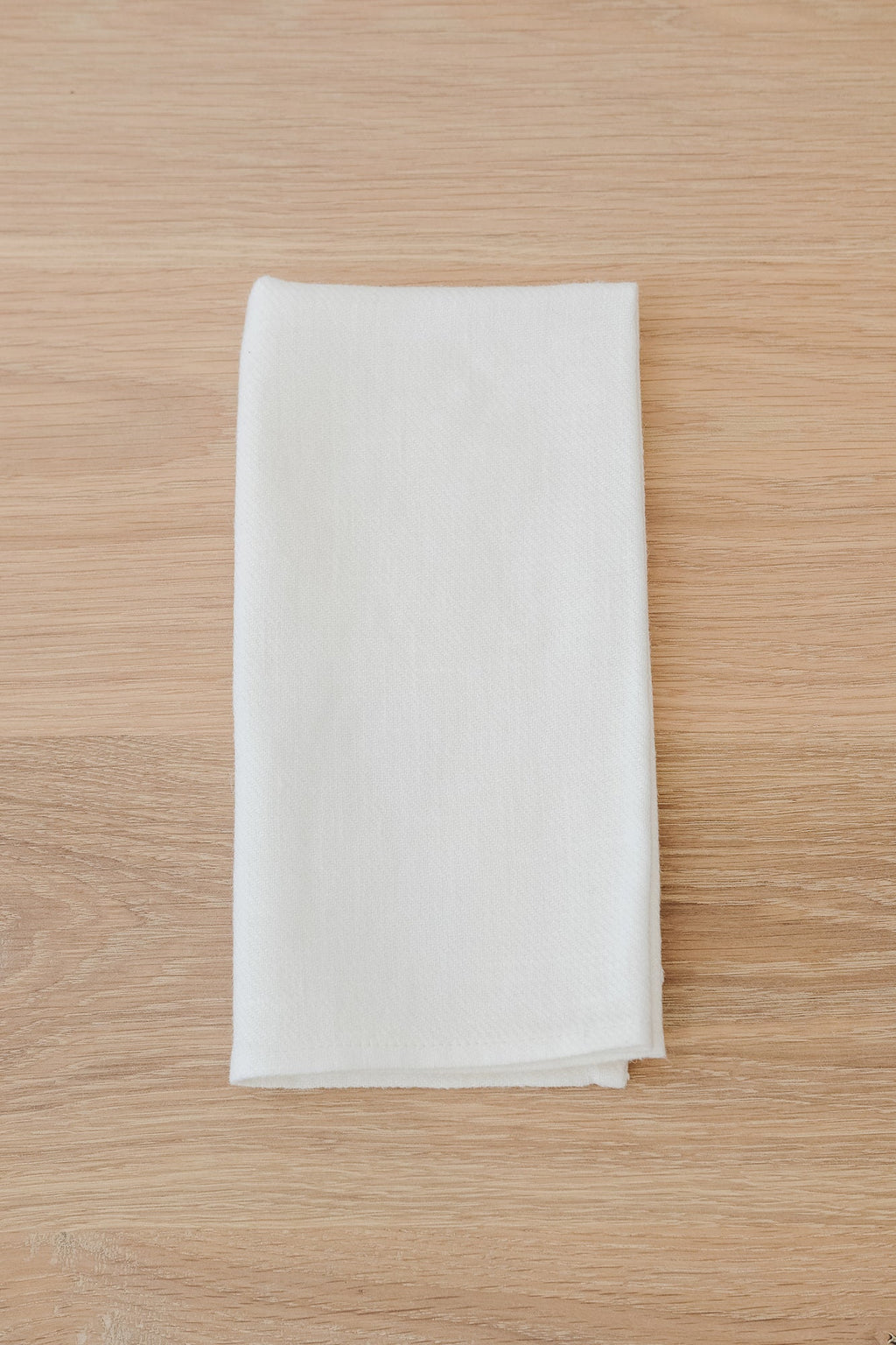 Ivory linen napkin made from high-quality European linen on wooden surface