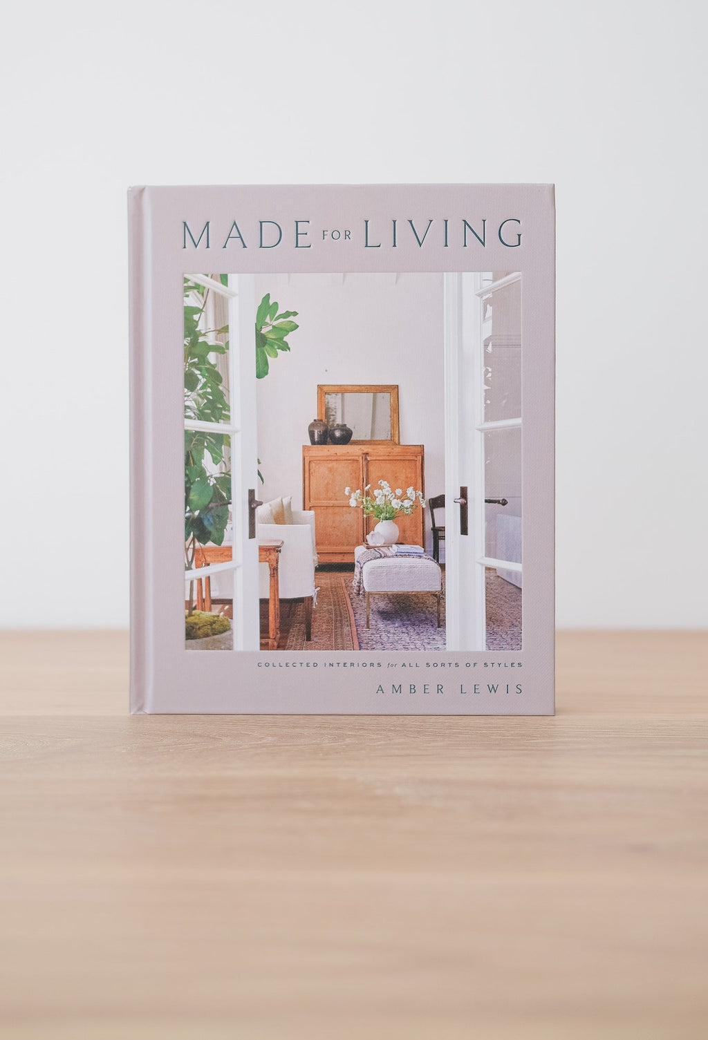 Made For Living book by Amber Lewis featuring interior design with a cozy living room scene