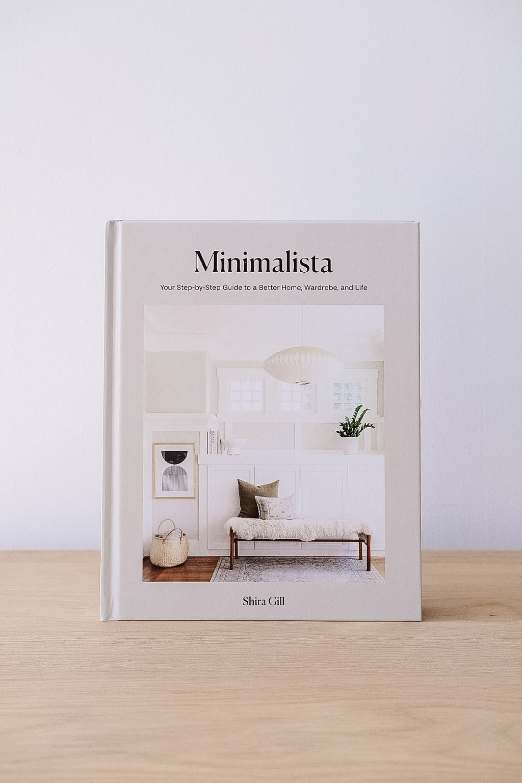 Minimalista book by Shira Gill on decluttering and organization with a minimalist home interior on the cover
