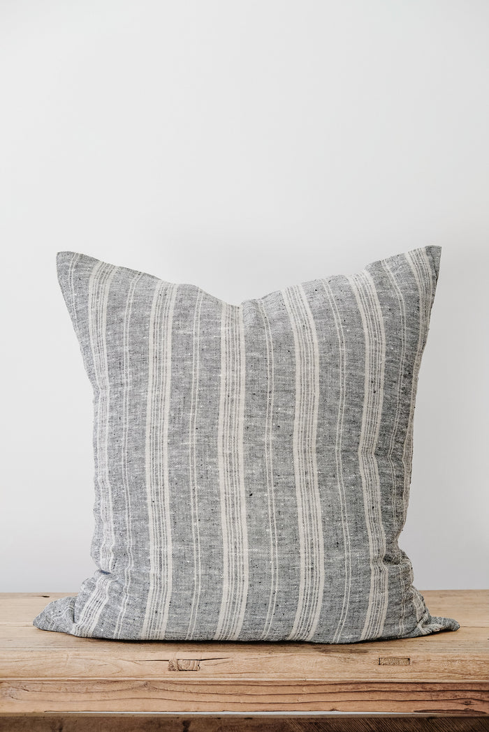 Front view of No. 48 - Striped Linen Pillow on an Antique Bench against a white wall. - Saffron and Poe