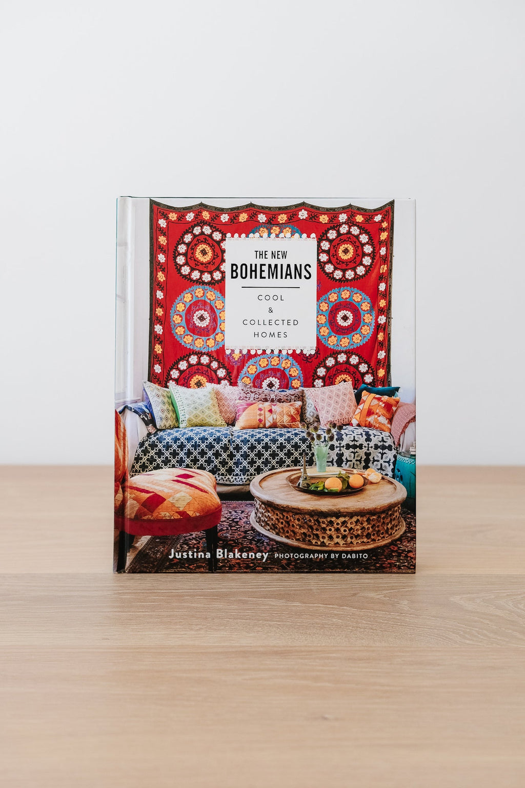 The New Bohemians book cover featuring a colorful boho living room with patterned textiles and a wooden coffee table