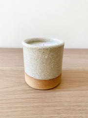 Uzumati Ceramic Bali Moon Candle in rustic stoneware with sand-toned base and speckled white glaze on wooden surface