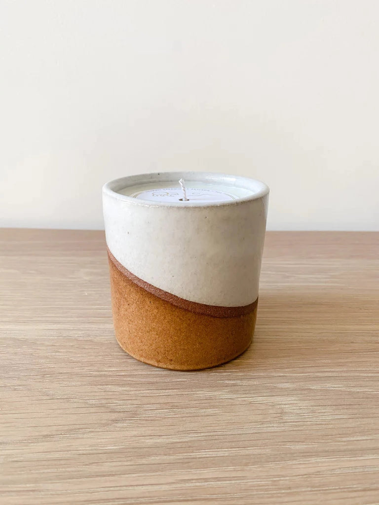 Front view of Ceramic Desert in Bloom Candle against a white background on an oak table. - Saffron and Poe