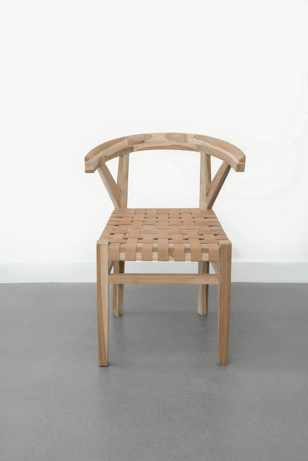 Woven leather wishbone dining chair with natural teak frame and beige leather strap seat