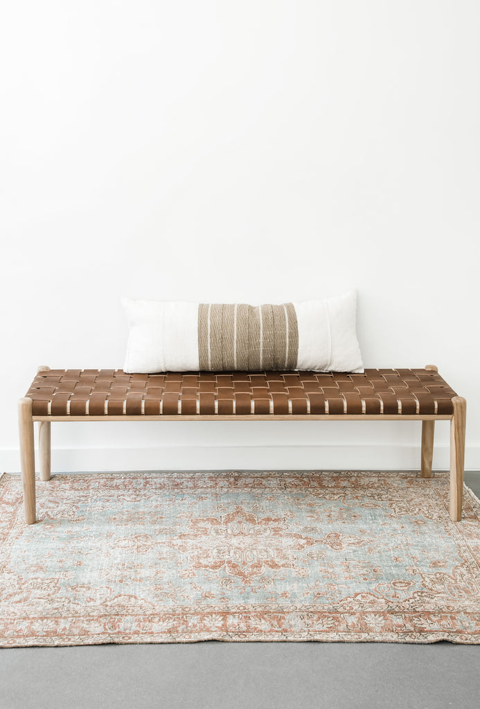 Teak framed Woven Leather Strap Bench styled over a rug with accent pillow. Furniture Handcrafted in Bali.- Saffron and Poe