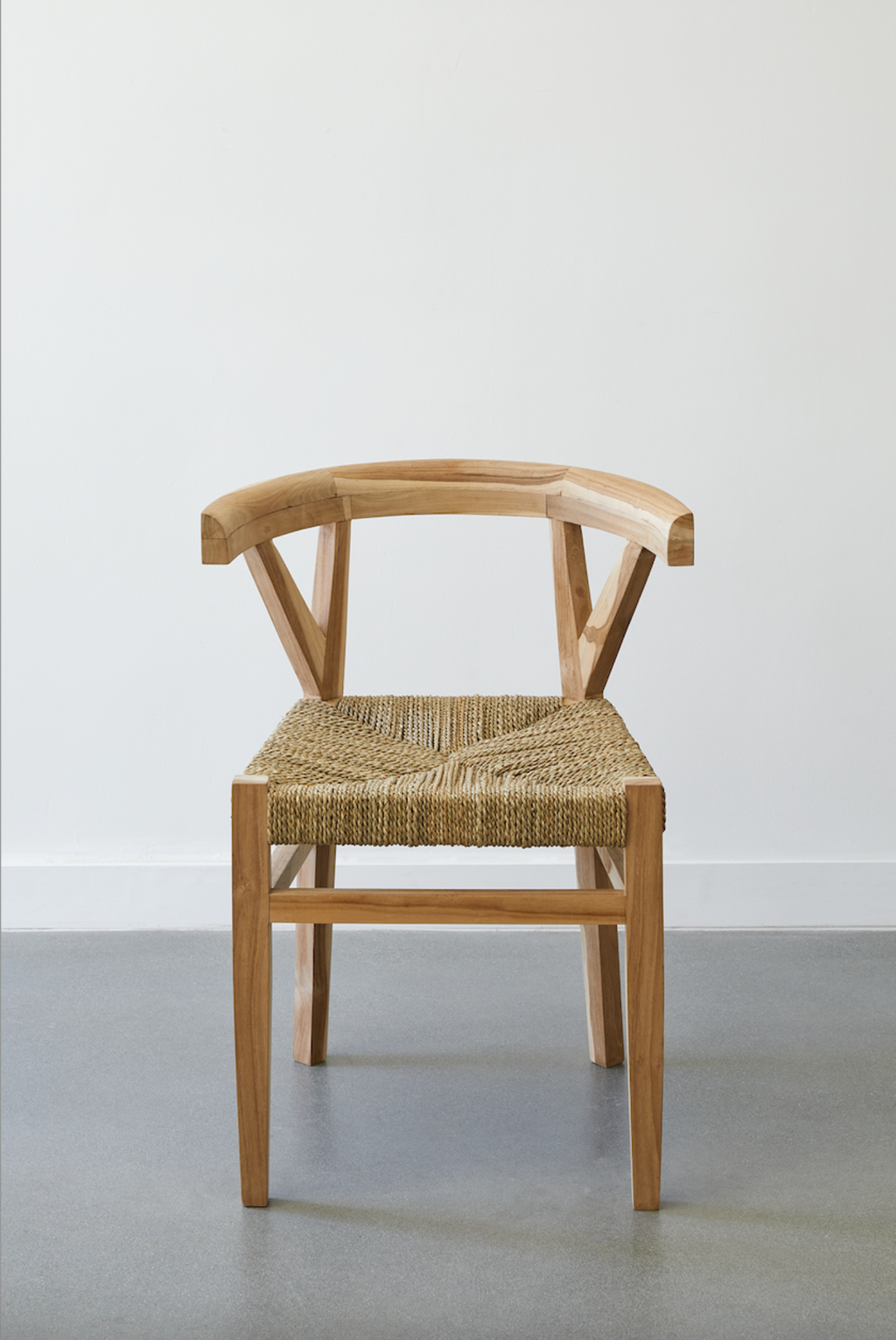 Woven Wishbone Dining Chair with braided rattan seat and curved teak wood frame against plain background