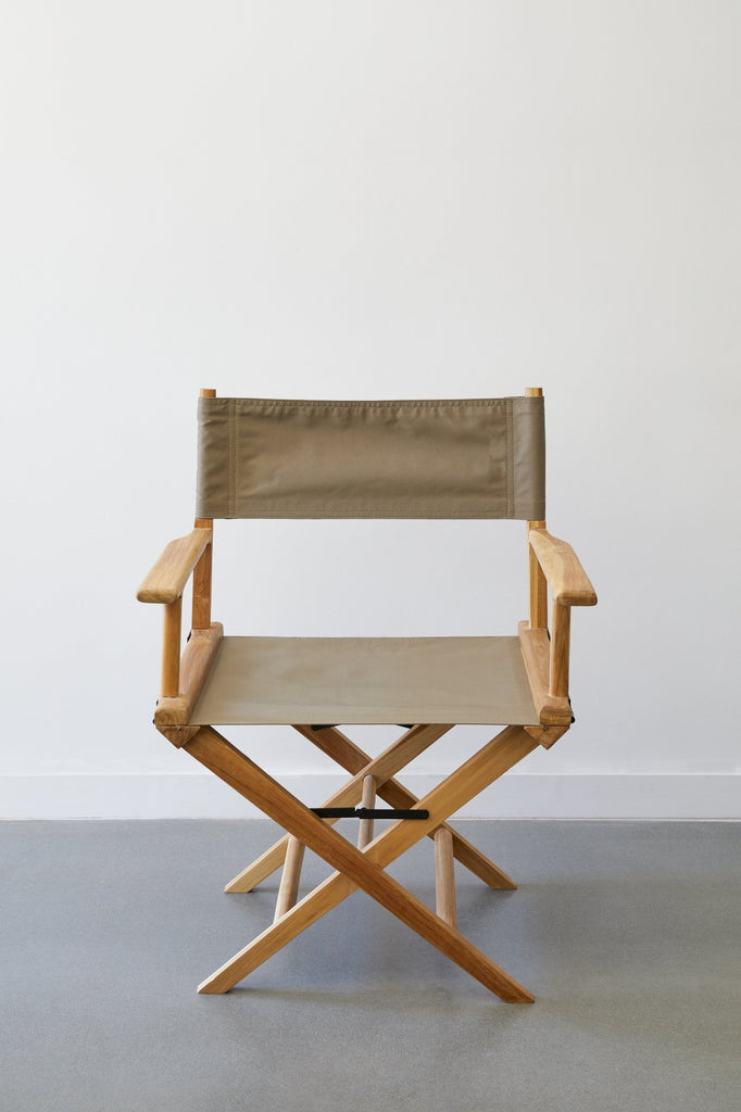 Front view of Taupe Canvas Director's Chair against white background on concrete flooring. - Saffron and Poe