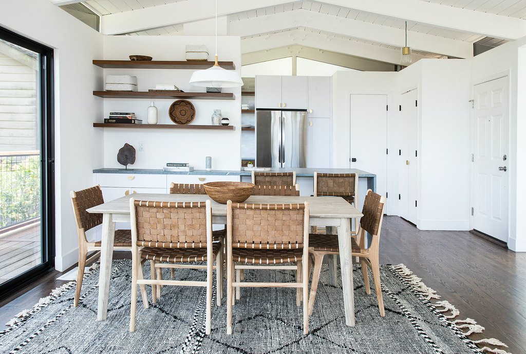 White open kitchen farmhouse table styled with Woven Leather Strap Dining Chair - Saddle. Handmade in Bali with Teak wood and vegetable-tanned leather imported from Java. - Saffron and Poe