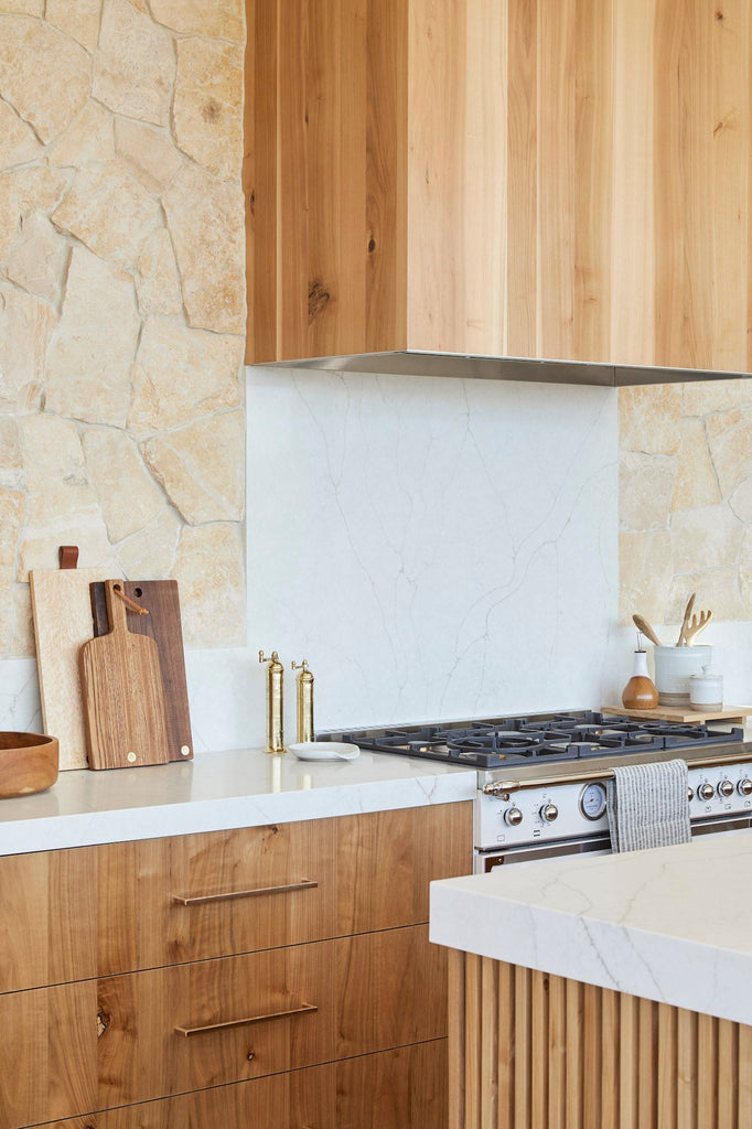 Styled Atlas Brass Grinders in a kitchen with Studio Inko Cutting Boards, a teak salad bowl, an Uzumati Ceramic Olive Oil Bottle, and Hanselmann Hand Thrown Ceramics. - Saffron and Poe