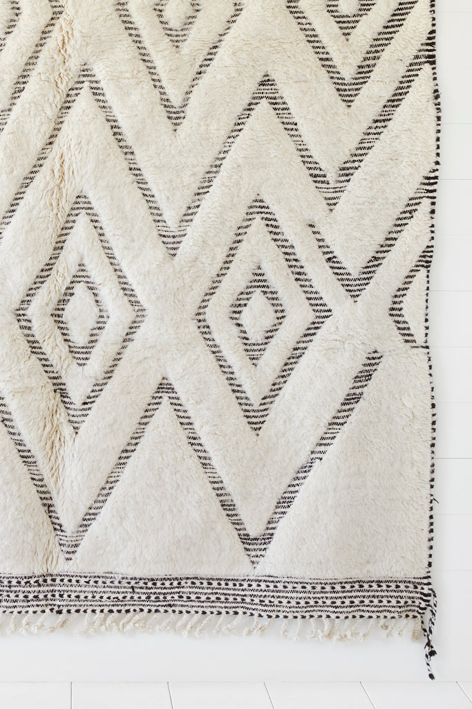 Close up view of No. 23 - Beni Ourain Rug against a white background. - Saffron and Poe