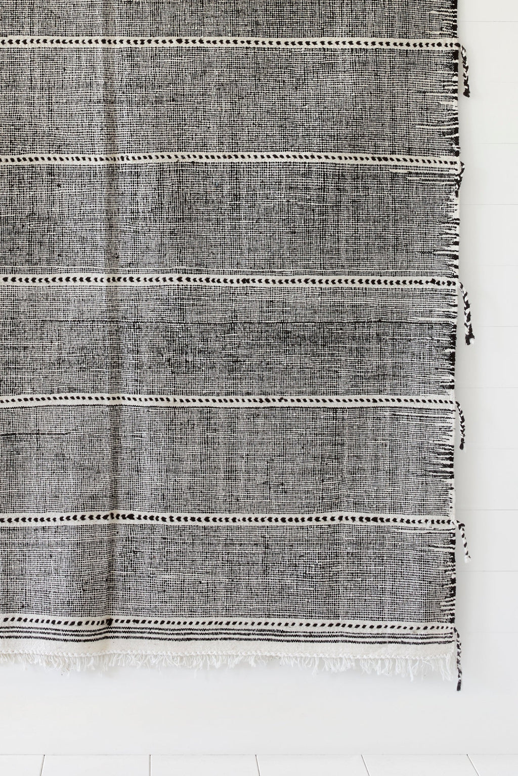 Gray and white Moroccan flat weave Kilim rug with thin horizontal lines and fringe edges