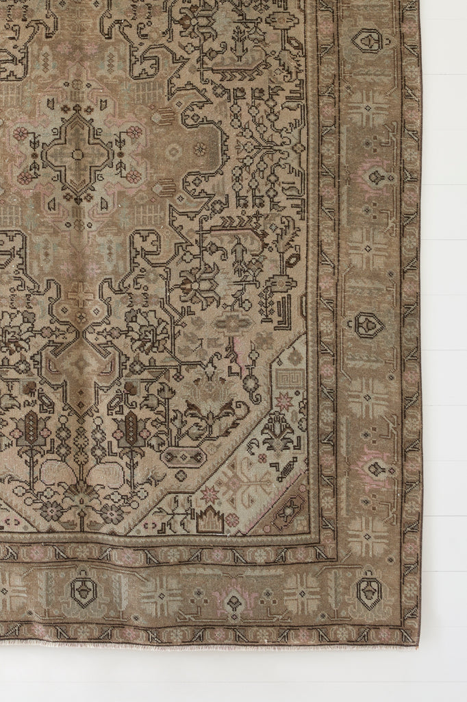 Close up view of No. 55 - Vintage Turkish Oushak Rug against a white background. - Saffron and Poe
