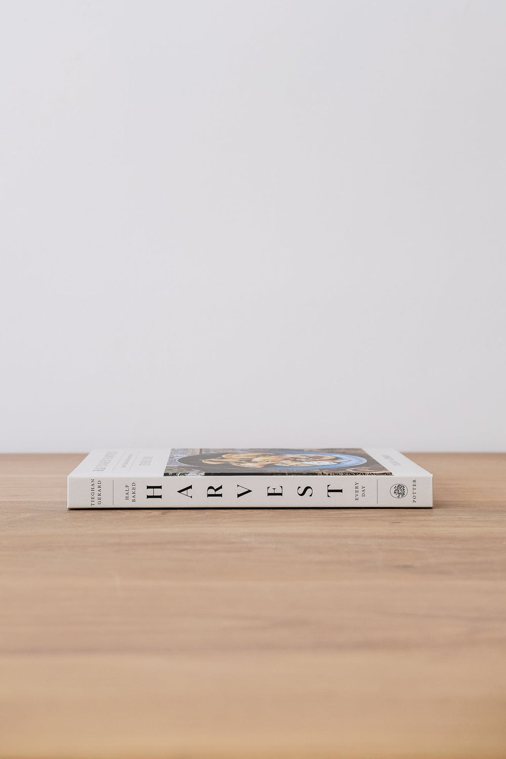 Half Baked Harvest cookbook lying flat on wooden surface against plain background