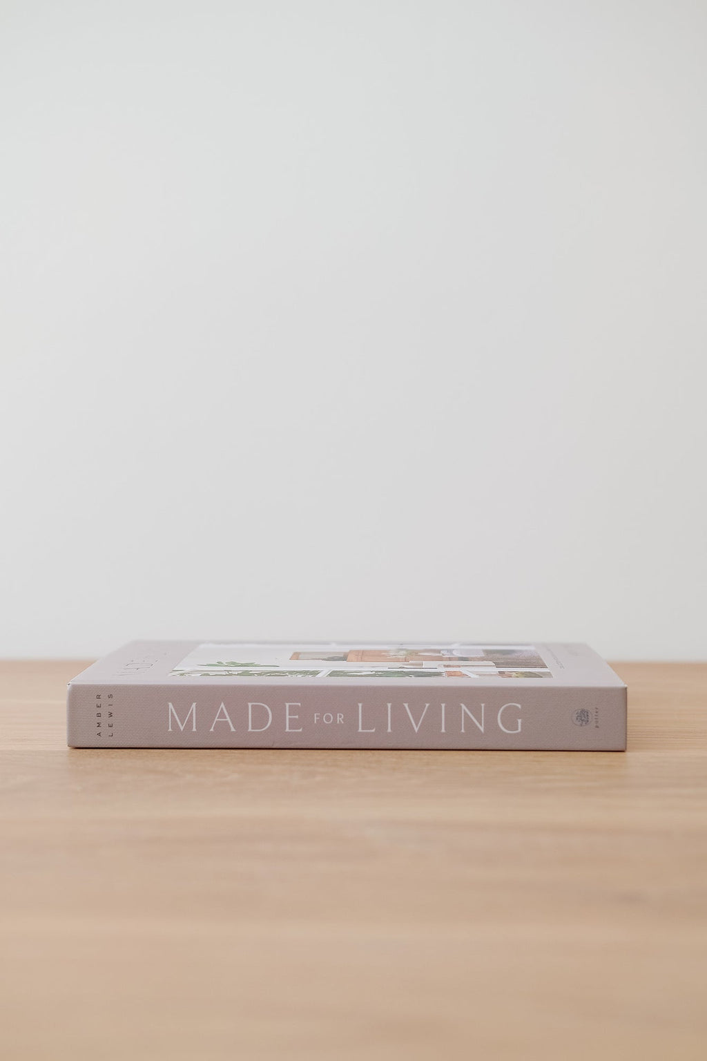 Made For Living book by Amber Lewis on wooden surface against white background