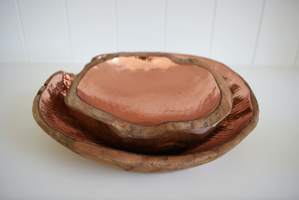 Set of stacked Hammered Copper and Teak Root Bowls handcrafted in Bali on a white background. -Saffron and Poe