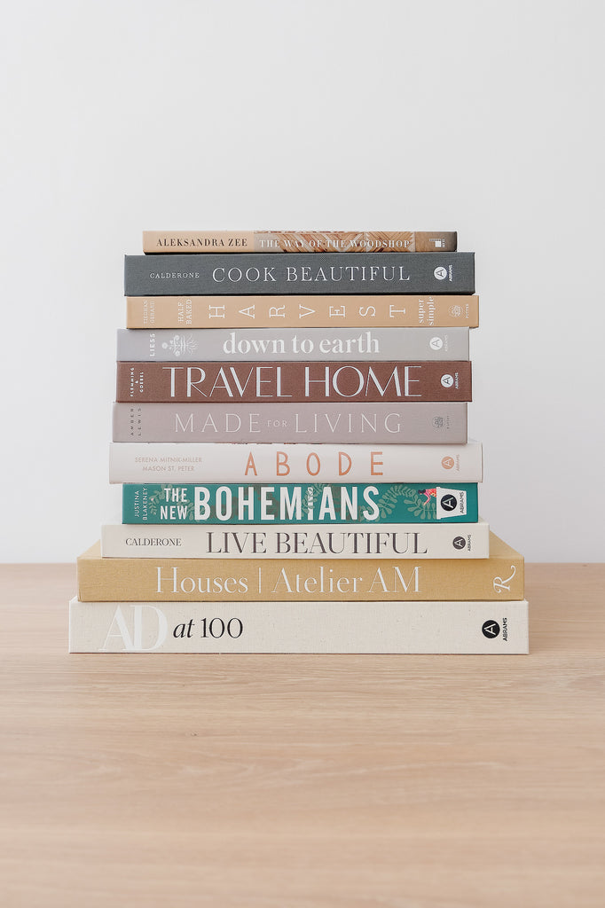 Architectural Digest at 100 with stacked book collection - Saffron and Poe