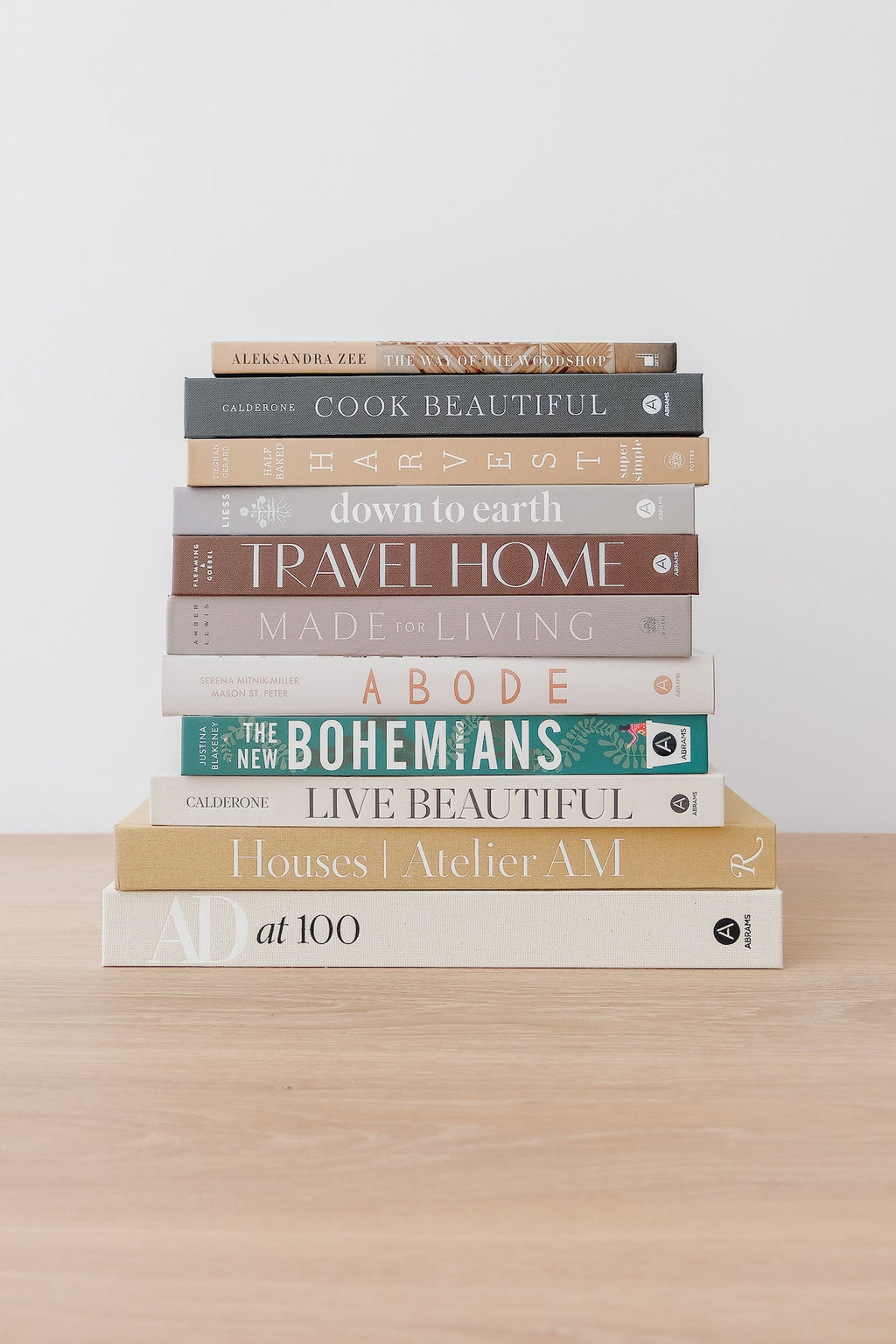 Stack of home and lifestyle books including The New Bohemians on a wooden table
