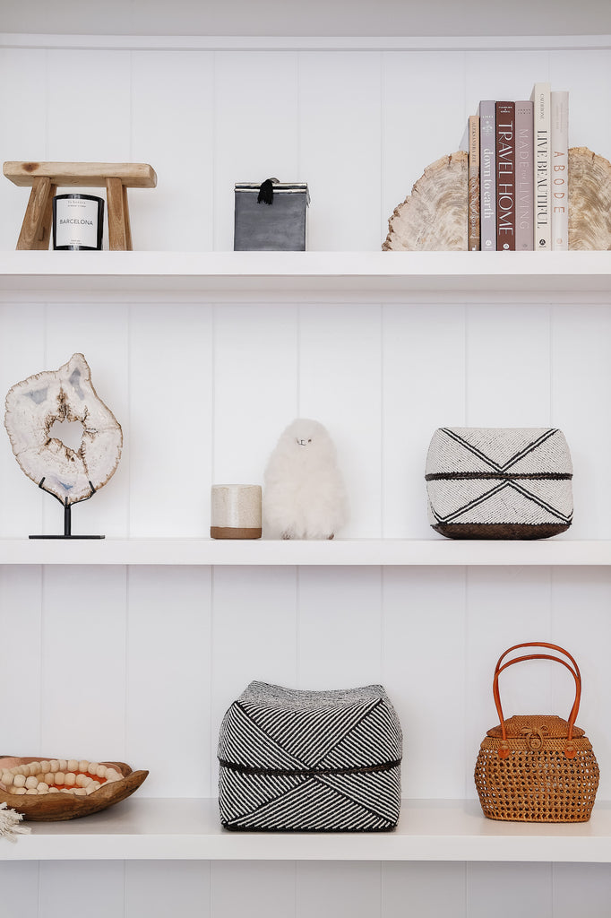 Styled Alpacquita on a shelf with Bali Baskets and books. - Saffron + Poe