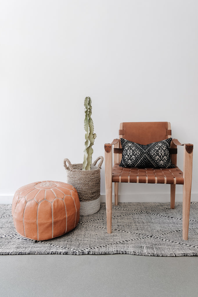 Styled view of Embroidered Leather Moroccan Pouf with leather Strap Safari Chair. - Saffron and Poe