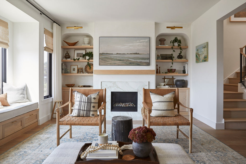 Styled Leather Strap Safari Lounge in a contemporary living room with Bhujodi Pillows, Turkish Rug, Wall Basket, Antique Clay Pot, Uzumati Candle, and Bali Beads. - Saffron and Poe