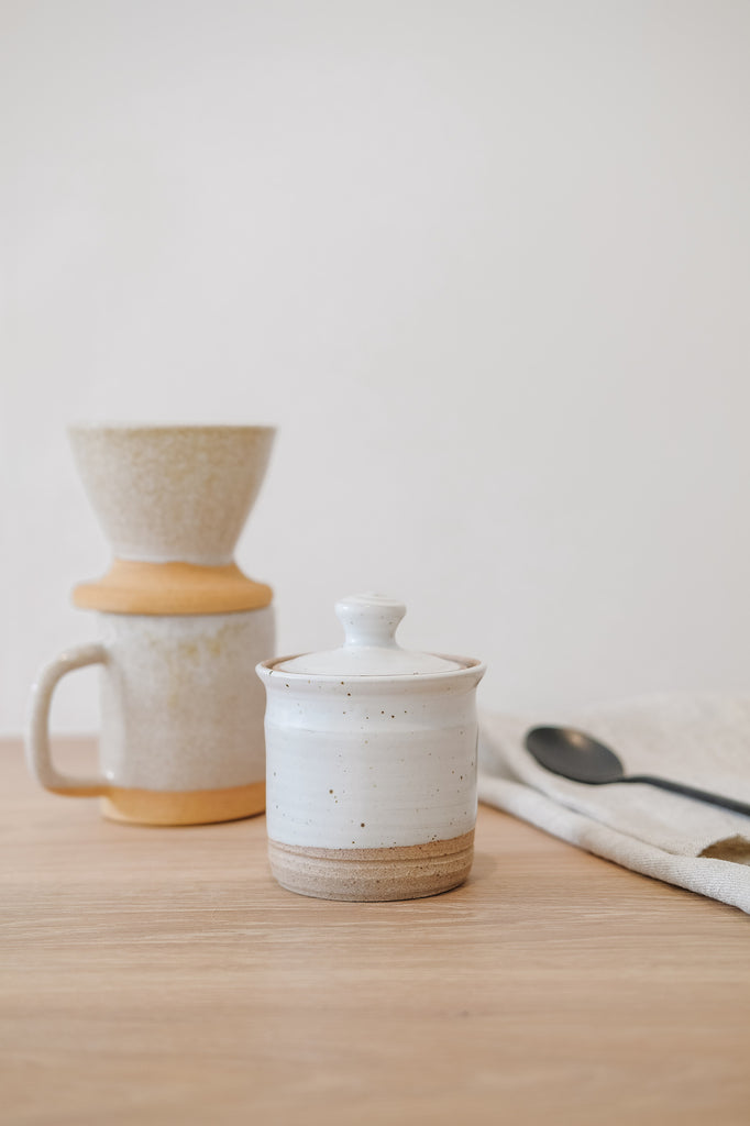 Styled Hanselmann Ceramic Sugar Canister with Uzumati Ceramics and a linen hand towel. - Saffron and Poe