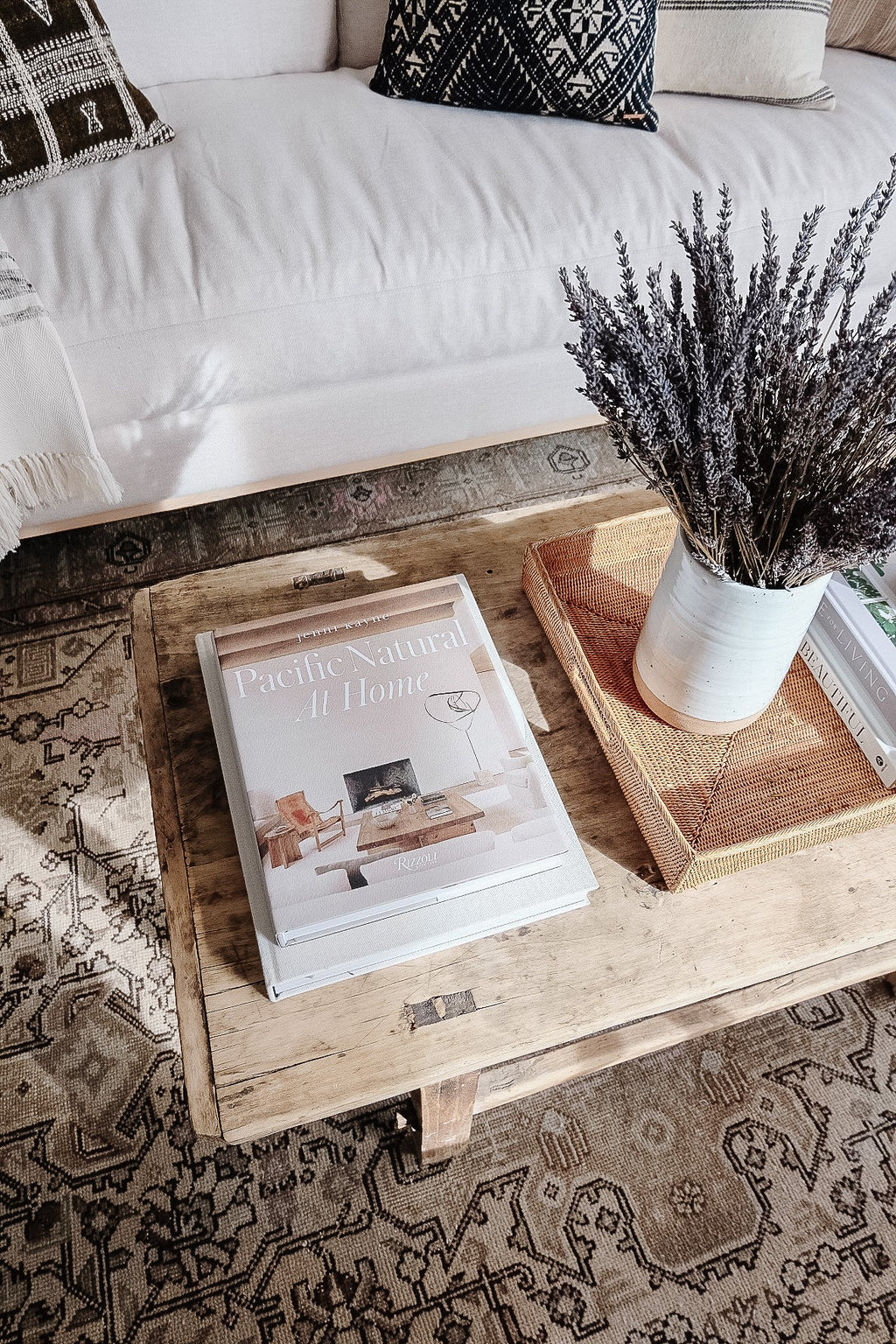 Cozy living room with Pacific Natural: At Home book on wooden coffee table and rustic decor elements