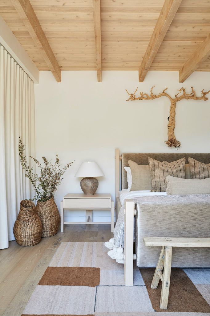 Styled Sculptural Nest Basket in a neutral bedroom with an Antique Chinese Bench and a Moroccan Pom Pom Throw Blanket. - Saffron and Poe