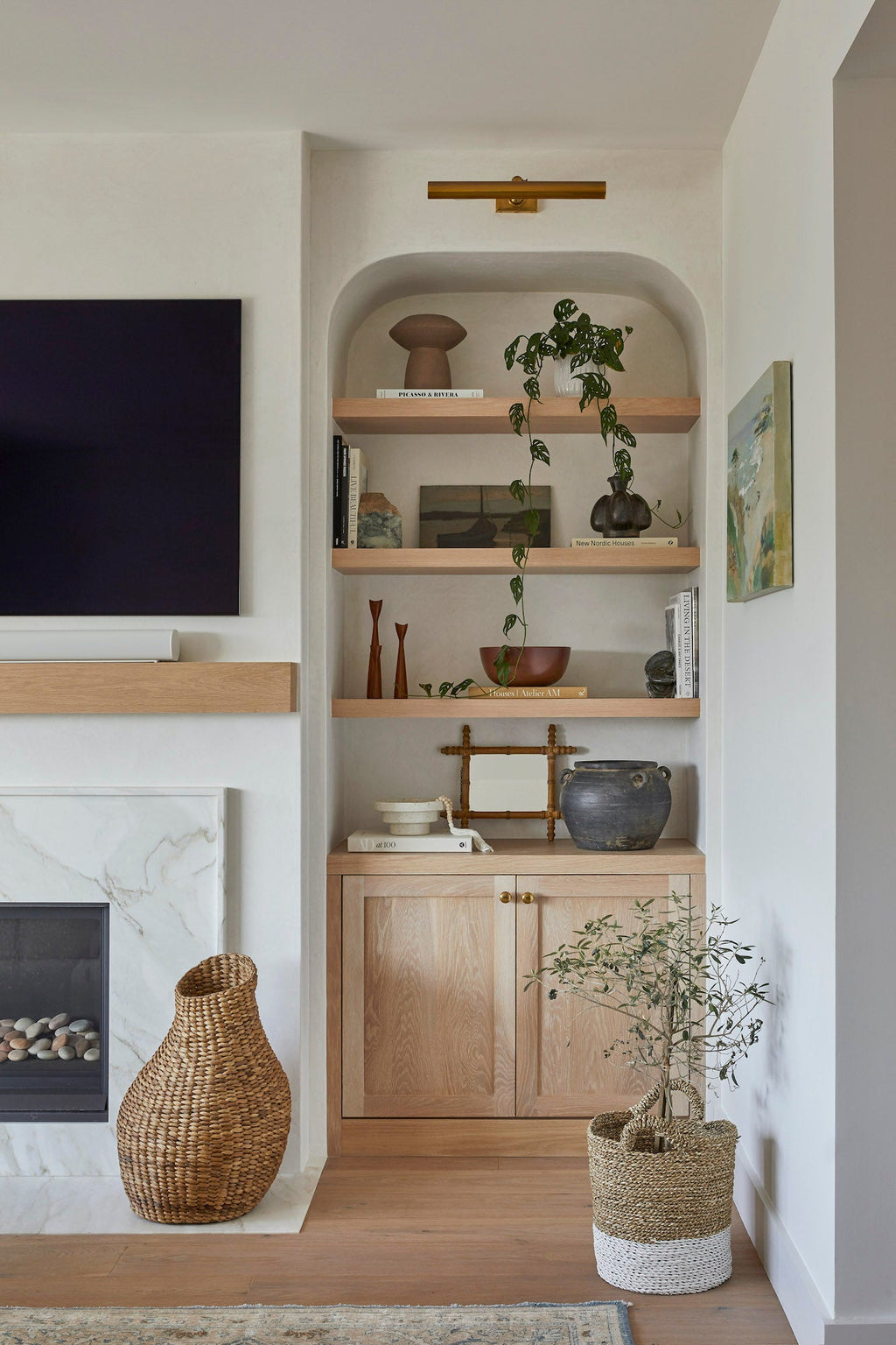 Two-toned handcrafted Structured Hyacinth Storage Basket in stylish modern room next to fireplace and wooden shelves