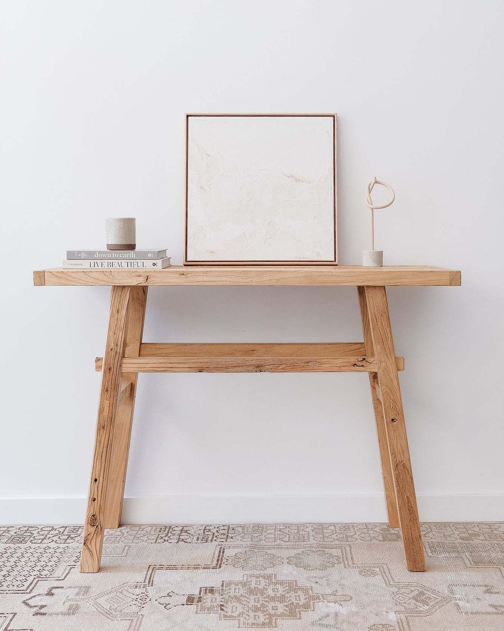 Vintage console table made of reclaimed elmwood in traditional Chinese style with minimalist decor on top.