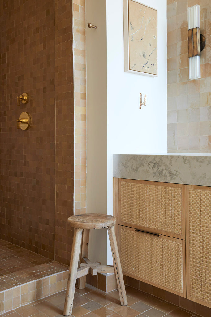Styled Vintage Elmwood Stool in a tiled bathroom with a rattan vanity.  Saffron and Poe