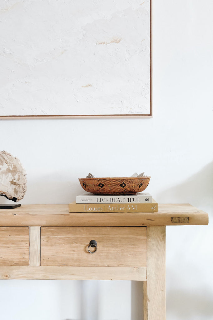 Styled Vintage Elmwood Storage Console with a Tenganan Basket and Petrified Wood Sculpture. - Saffron and Poe