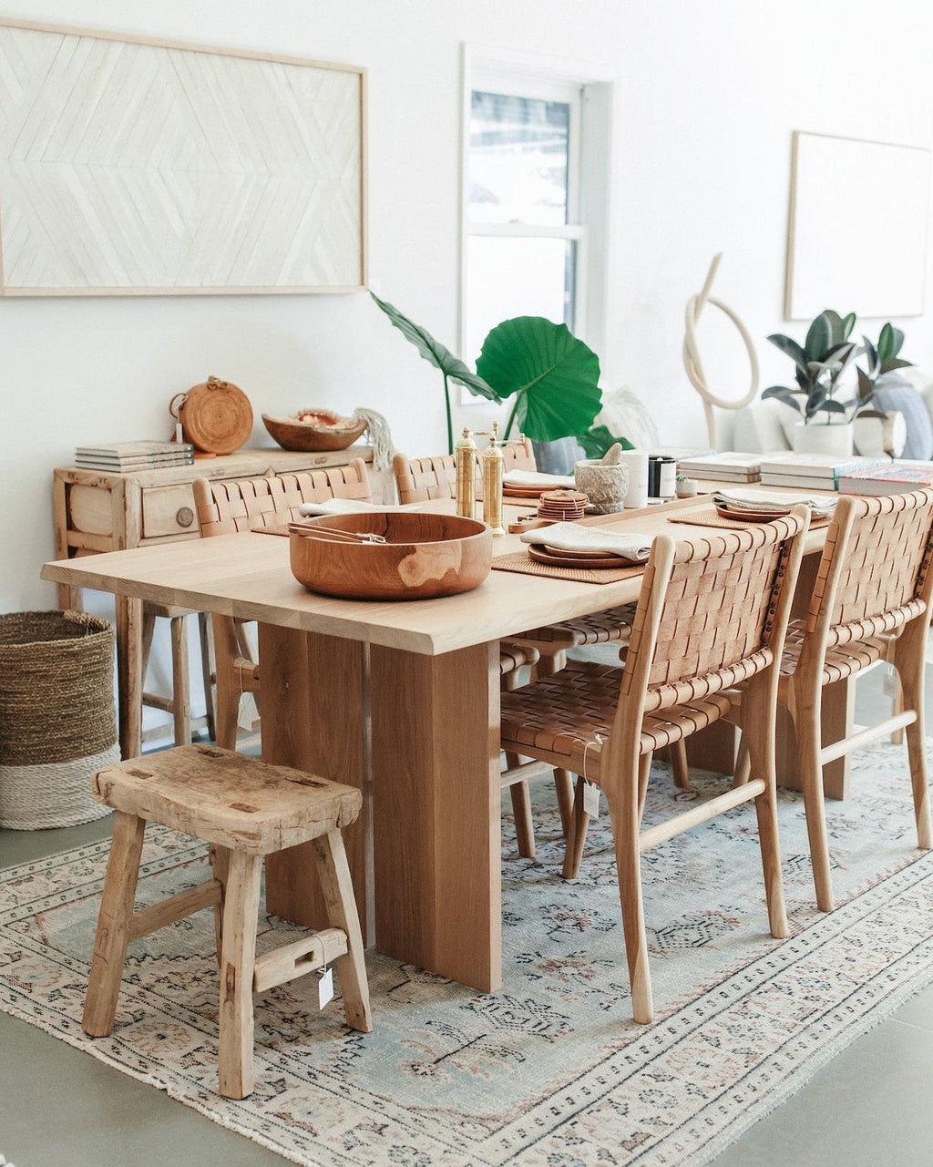 Handcrafted antique stool made of solid elmwood with rustic patina in a bright modern dining room