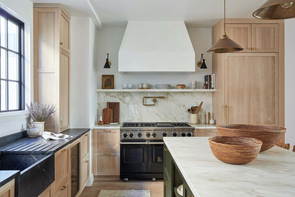 Modern kitchen with wooden cabinets and two woven Tenganan baskets on marble island counter