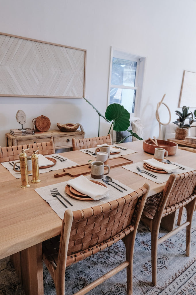 Styled Ivory Linen Napkin with Teak Plates, Brass Grinders, and a Ceramic Mug. - Saffron and Poe