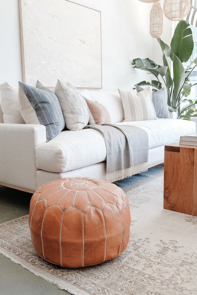 Styled Embroidered Leather Moroccan Pouf in a living room. - Saffron and Poe