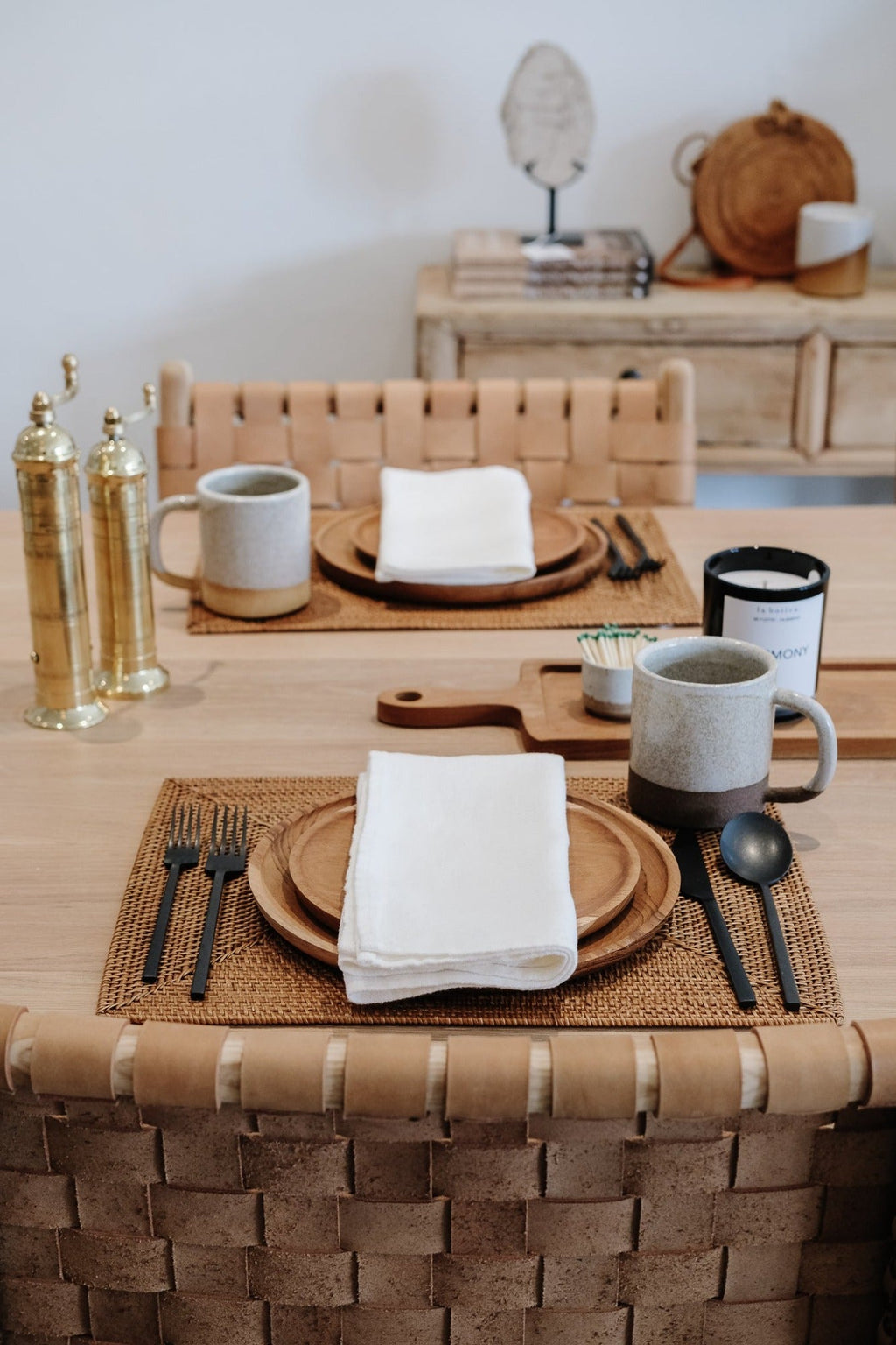 Ivory European linen napkin on rustic dining table setting with ceramic mug and woven placemat