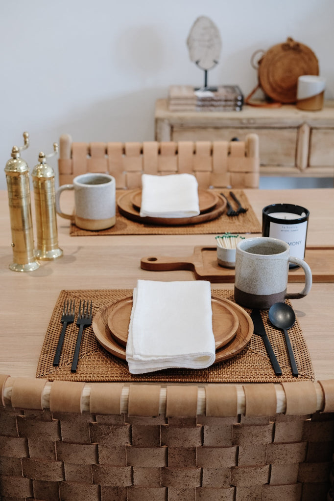 Styled Ivory Linen Napkin with Teak Plates, Brass Grinders, and a Ceramic Mug. - Saffron and Poe