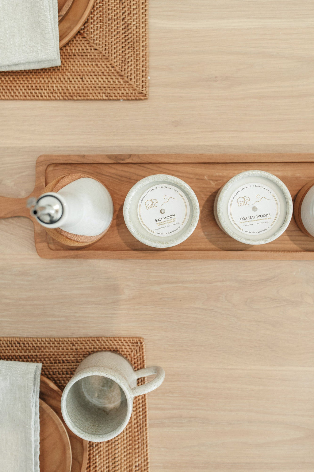 Uzumati Ceramic Coastal Woods Candle in rustic glaze-dipped stoneware vessel with matching mug on wooden table setting
