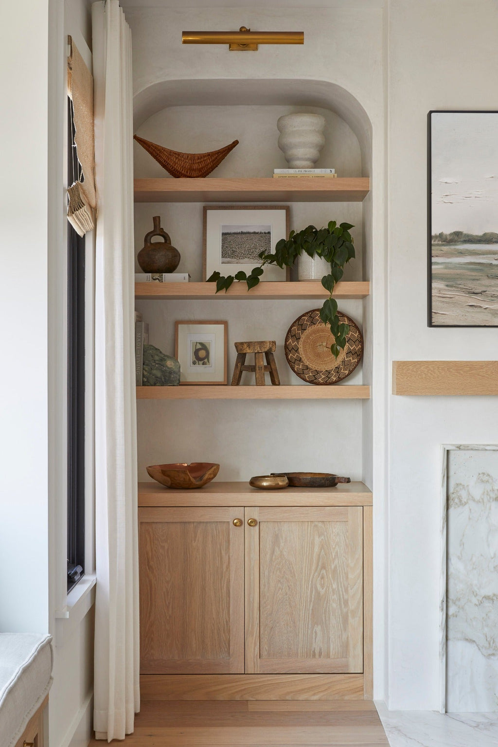 Ilala palm wall baskets displayed on wooden shelves in a cozy living space.