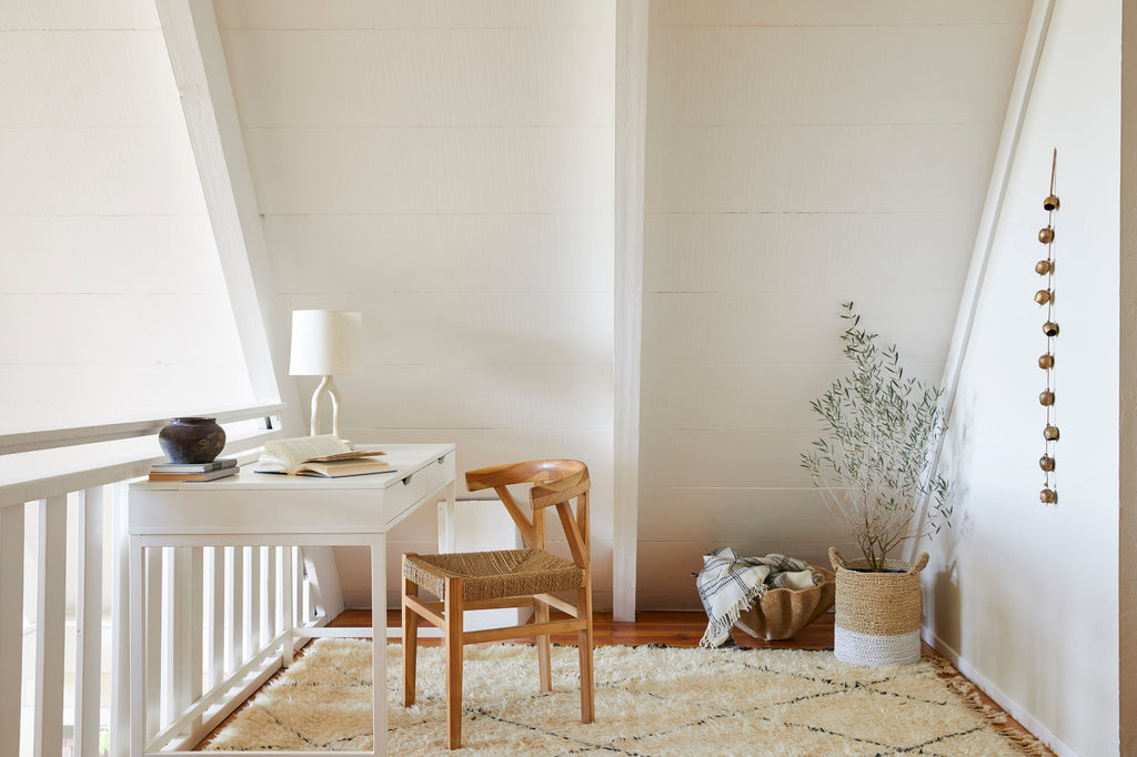 Styled view of our dancing basket with Handwoven Bhujodi Blanket, in an office nook setting with our Structured Hyacinth Storage Basket, Beni Ourain Rug, Rattan Curved Back Dining Chair, and Antique Clay Pot. - Saffron and Poe