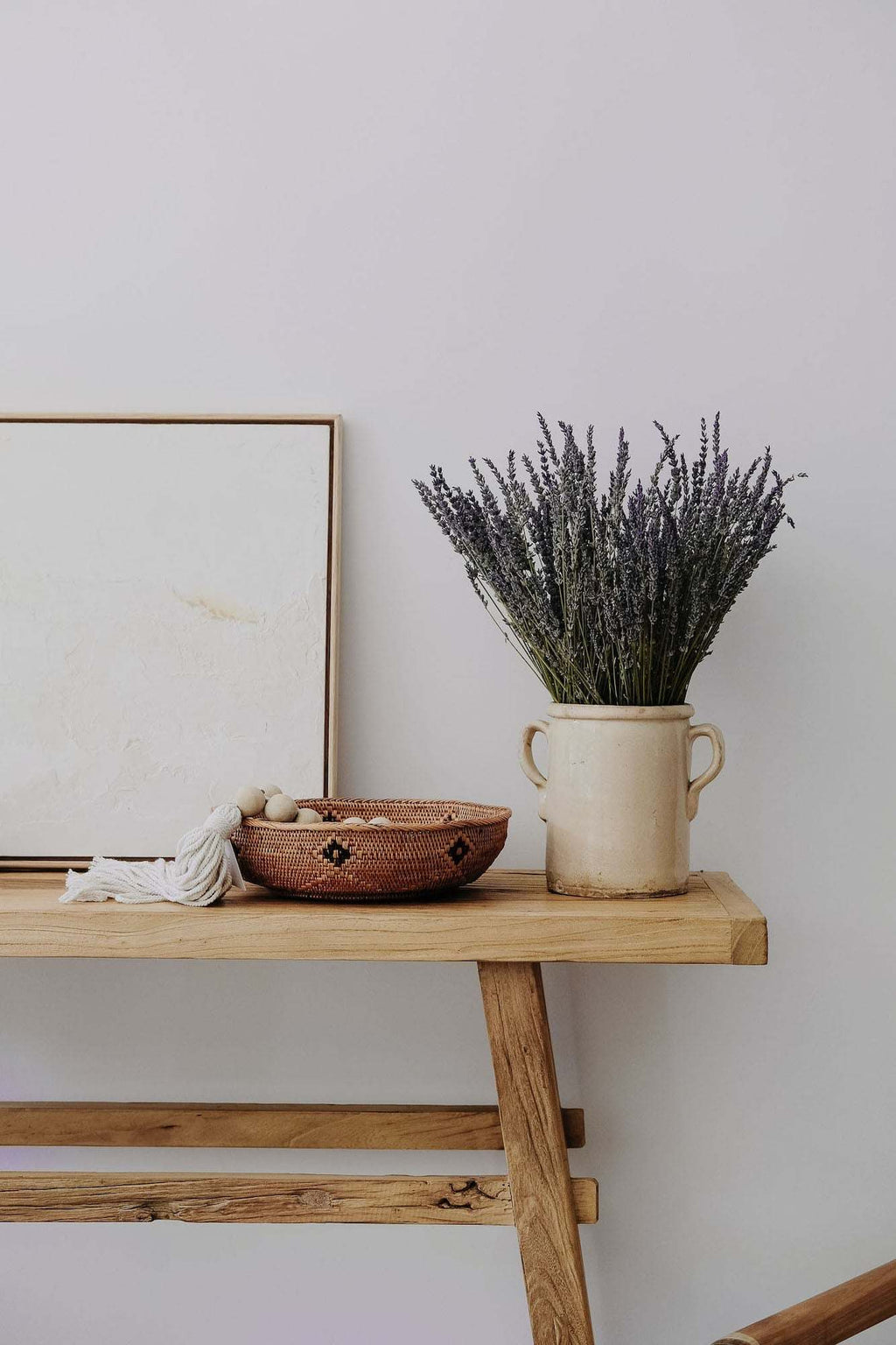 Handwoven Black and Natural Tenganan Basket on wooden table with decorative vase and art piece